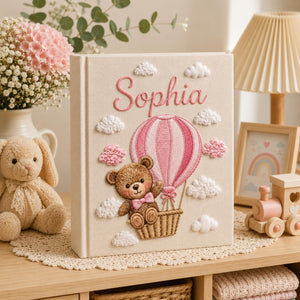 Personalized hand embroidered baby photo album with teddy bear in pink hot air balloon and fluffy embroidered clouds