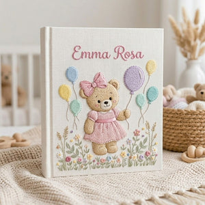 Personalized hand embroidered photo album featuring a birthday teddy bear holding pastel balloons in a blooming flower garden