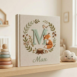 Personalized woodland fox monogram embroidered baby photo album with forest leaves and custom name on linen cover