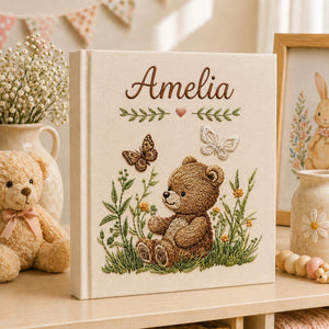 Personalized embroidered baby photo album with woodland teddy bear, butterflies, and greenery design