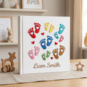 Personalized hand embroidered photo album featuring colorful baby footprints with heart details and custom baby name on linen cover