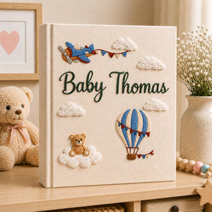 Personalized hand embroidered baby photo album with hot air balloon, airplane, clouds, and teddy bear embroidery