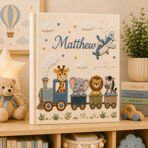 Personalized hand embroidered photo album featuring an adventure train with animal friends, stars, clouds and vintage airplane