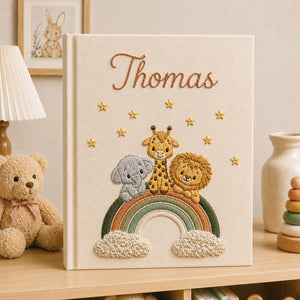 Personalized hand embroidered baby photo album with safari animals sitting on rainbow