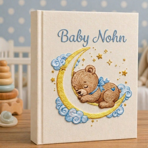 Personalized hand embroidered photo album featuring a sleeping teddy bear resting on a crescent moon with clouds and golden stars