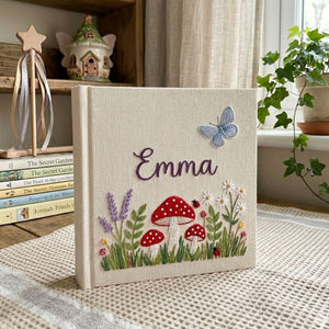Personalized woodland mushroom embroidered baby photo album with whimsical forest design on linen cover