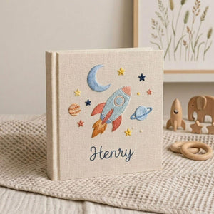 Personalized embroidered baby photo album with space rocket, moon, planets, stars, and custom name embroidery