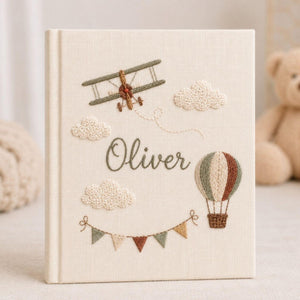 Personalized adventure hand embroidered baby photo album with airplane hot air balloon and cloud design on linen cover