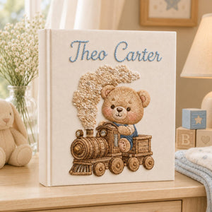 Personalized hand embroidered baby photo album with teddy bear riding a vintage steam train