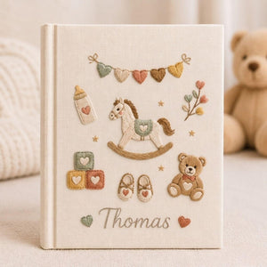 Personalized baby toys hand embroidered photo album with rocking horse teddy bear and nursery accessories on linen cover