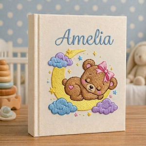 Personalized hand embroidered photo album featuring twinkling stars, pastel clouds, celestial nursery details and custom baby name embroidery
