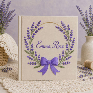 Personalized hand embroidered photo album featuring a lavender floral wreath with an elegant purple bow on a premium linen cover customized with a name
