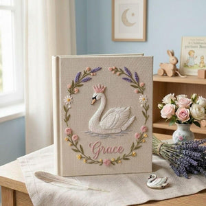 Personalized swan princess hand embroidered baby photo album with floral wreath nursery design on linen cover