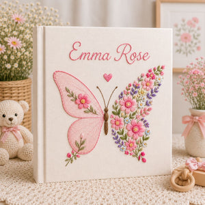 Personalized hand embroidered photo album featuring a floral butterfly with pink wildflowers, lavender accents, and custom name embroidery on a premium linen cover