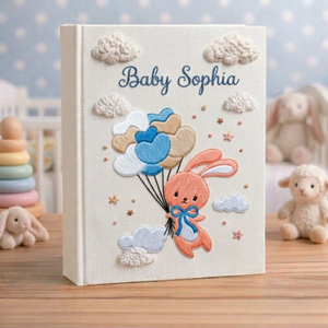 Personalized hand embroidered photo album featuring a bunny holding pastel heart balloons floating among fluffy clouds