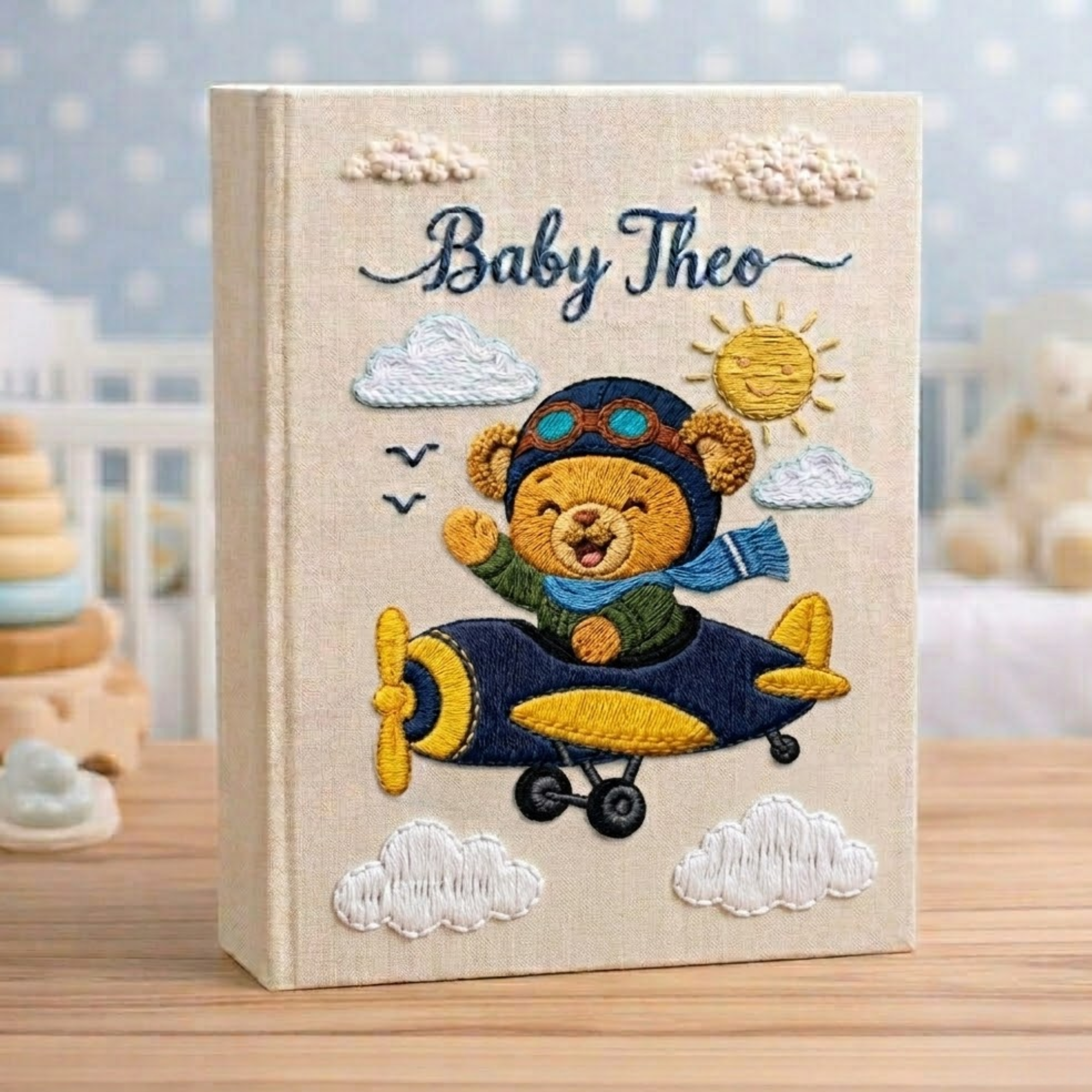 Personalized hand embroidered photo album featuring a teddy bear pilot flying a vintage airplane with clouds and stars