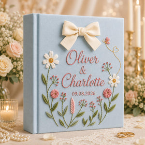 Personalized hand embroidered floral wedding photo album with bow detail and custom couple names on linen cover
