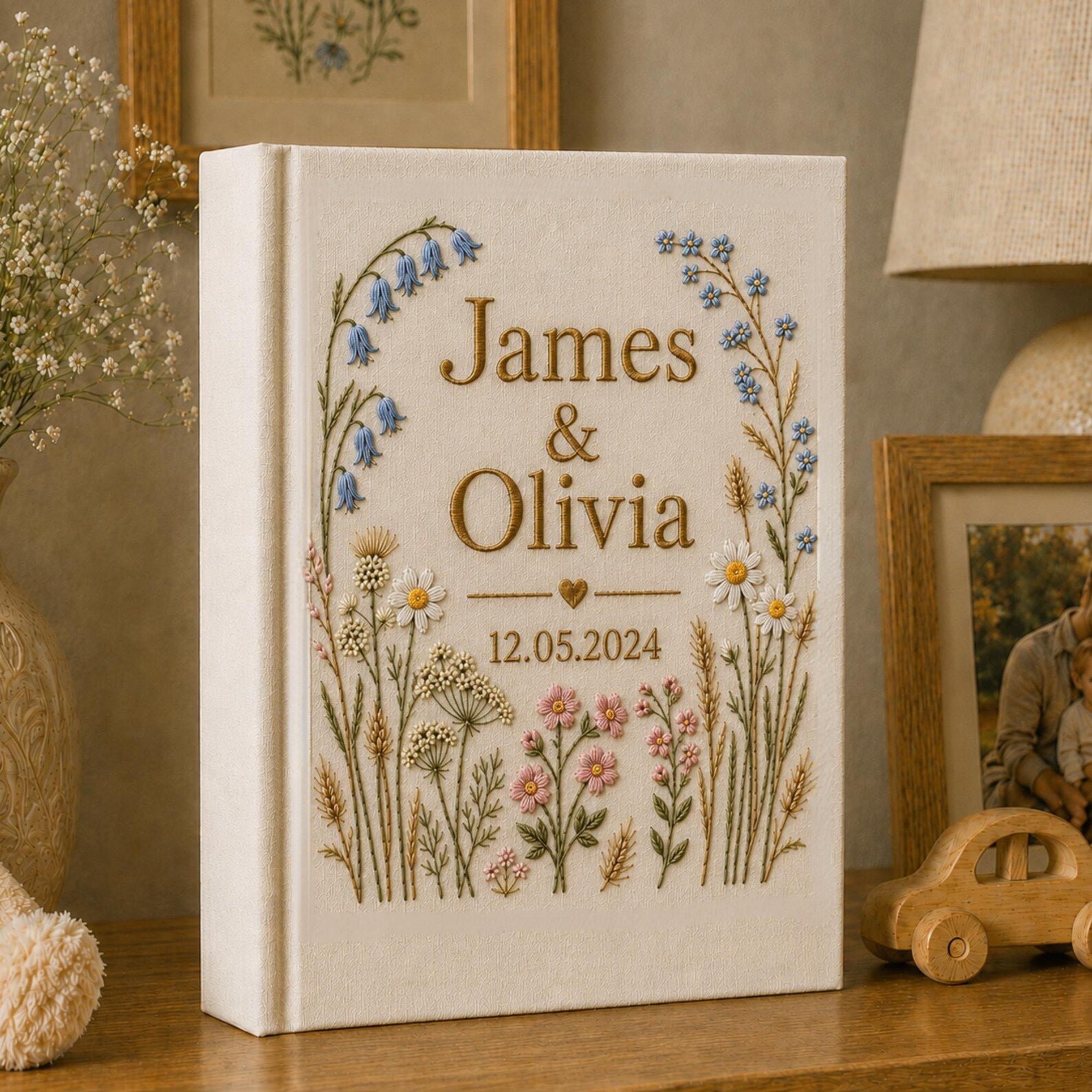 Personalized hand embroidered wildflower wedding photo album with botanical floral design and custom names on linen cover