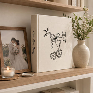 Personalized embroidered wedding photo album with minimalist birds ribbon hearts and custom initials on linen cover