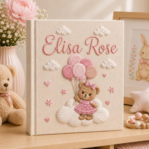 Personalized hand embroidered baby photo album with teddy bear holding pink balloons on clouds