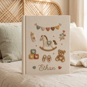 Personalized baby toys hand embroidered photo album with rocking horse teddy bear and nursery accessories on linen cover
