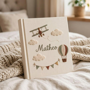 Personalized adventure hand embroidered baby photo album with airplane hot air balloon and cloud design on linen cover