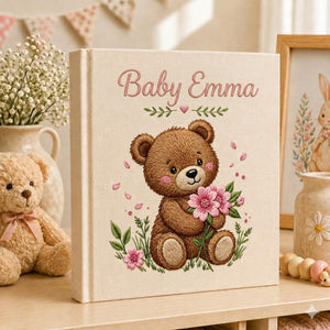 Personalized embroidered baby photo album with teddy bear holding pink flowers and floral nursery design