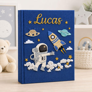 Personalized hand embroidered photo album featuring astronaut rocket planets stars and custom baby name on linen cover