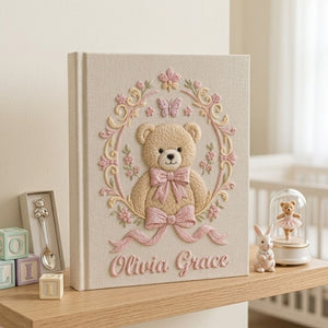 Personalized hand embroidered photo album featuring a vintage teddy bear surrounded by a floral wreath, pink bows and delicate butterfly accents