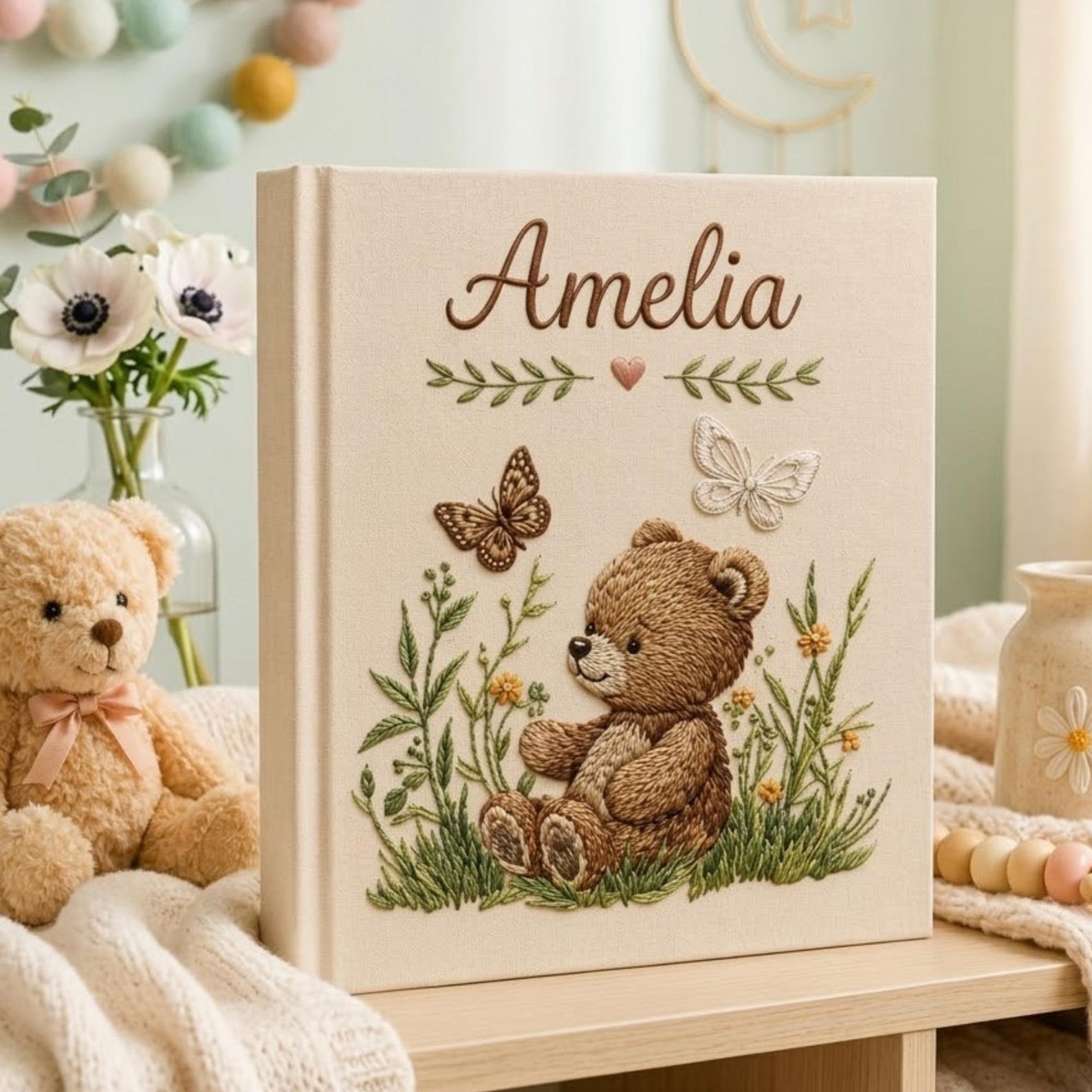 Personalized embroidered baby photo album with woodland teddy bear, butterflies, and greenery design