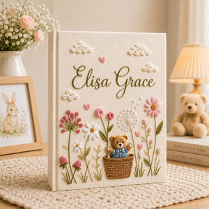 Personalized hand embroidered baby photo album with teddy bear basket wildflowers and cottagecore floral details