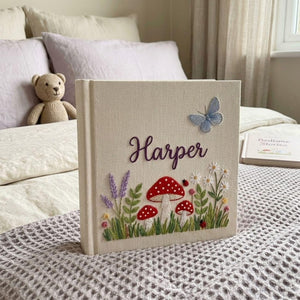 Personalized woodland mushroom embroidered baby photo album with whimsical forest design on linen cover