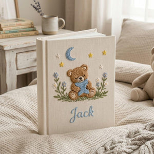 Personalized sleepy teddy hand embroidered baby photo album with moon star and bedtime nursery design on linen cover