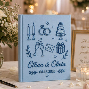 Personalized embroidered wedding photo album with wedding icons rings champagne cake and custom couple names on linen cover