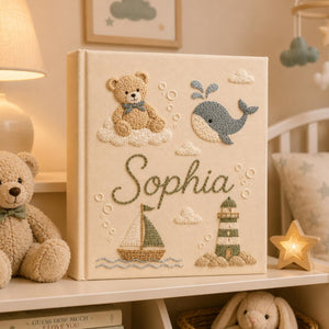 Personalized hand embroidered nautical baby photo album with sailor teddy bear, whale, sailboat, and lighthouse design