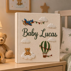 Personalized hand embroidered baby photo album with hot air balloon, airplane, clouds, and teddy bear embroidery