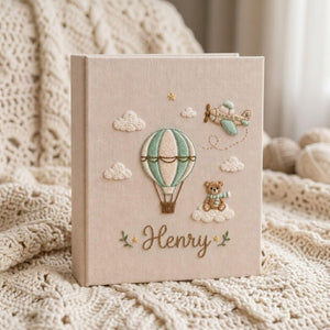 Personalized adventure travel hand embroidered baby photo album with hot air balloon airplane and teddy bear design on linen cover