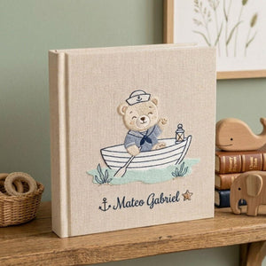 Personalized hand embroidered baby photo album with sailor teddy bear rowing a boat in a nautical nursery theme