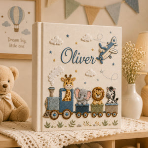 Personalized hand embroidered photo album featuring an adventure train with animal friends, stars, clouds and vintage airplane