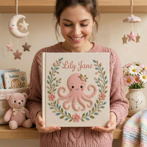 Personalized hand embroidered photo album featuring a cute pink octopus surrounded by floral wreath embroidery and pastel botanical details