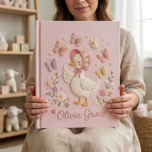 Personalized hand embroidered photo album featuring a cottage style goose wearing a floral bonnet surrounded by butterflies and flowers