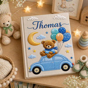 Personalized hand embroidered baby photo album featuring teddy bear on vintage blue car with balloons, moon, stars, and custom name embroidery