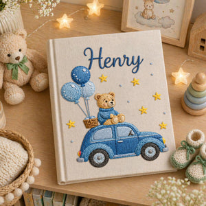 Personalized hand embroidered baby photo album featuring teddy bear riding a blue vintage car with balloons and stars on linen cover