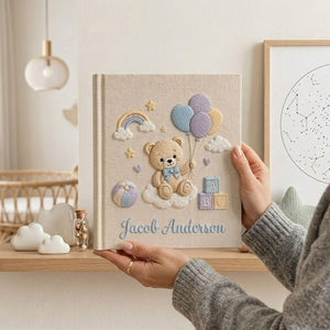 Personalized hand embroidered photo album featuring teddy bear holding pastel balloons with rainbow clouds ABC blocks and custom baby name