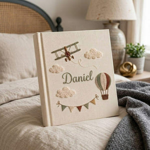 Personalized adventure hand embroidered baby photo album with airplane hot air balloon and cloud design on linen cover