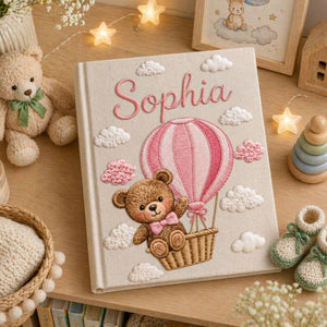 Personalized hand embroidered baby photo album with teddy bear in pink hot air balloon and fluffy embroidered clouds