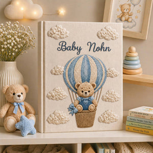 Personalized embroidered baby photo album with teddy bear in blue sky balloon basket and fluffy cloud embroidery