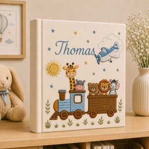 Personalized hand embroidered photo album featuring an adventure train with animal friends, stars, clouds and vintage airplane