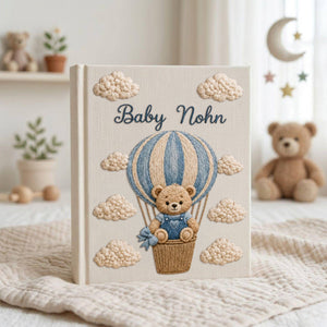 Personalized embroidered baby photo album with teddy bear in blue sky balloon basket and fluffy cloud embroidery