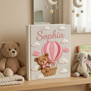 Personalized hand embroidered baby photo album with teddy bear in pink hot air balloon and fluffy embroidered clouds